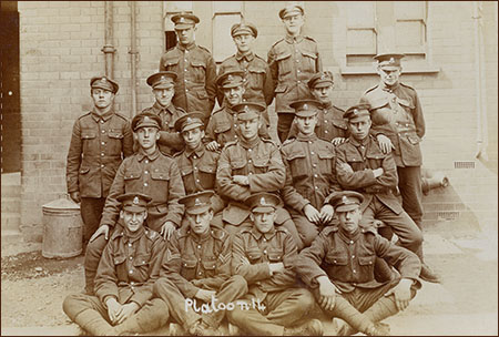 'Platoon 14' of the North Staffordshires. Edward Hodgkins sits in the exact centre, arms folded.